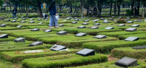 peaceful muslim cemetery with people mourning